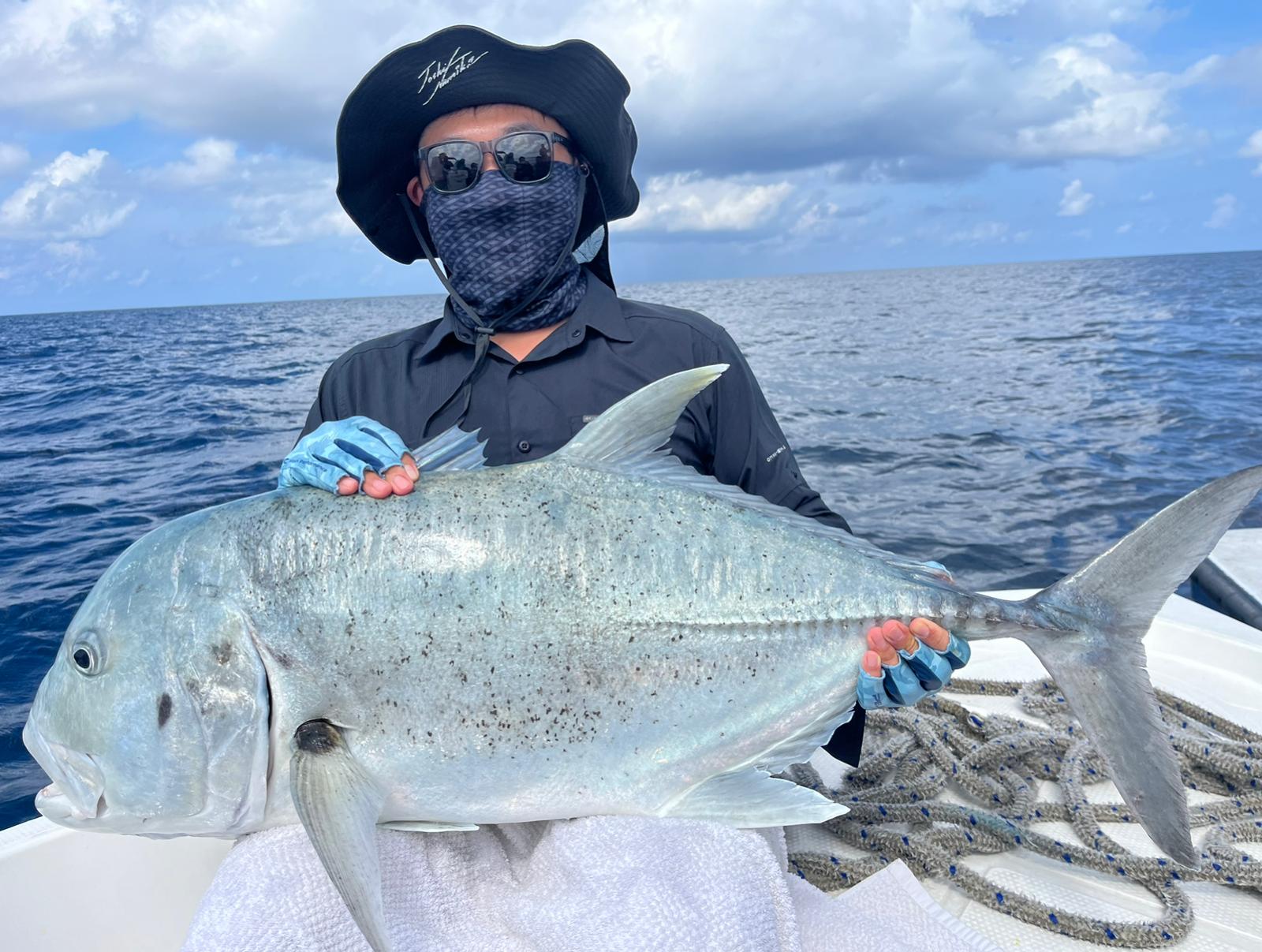 Angler holding a giant trevally